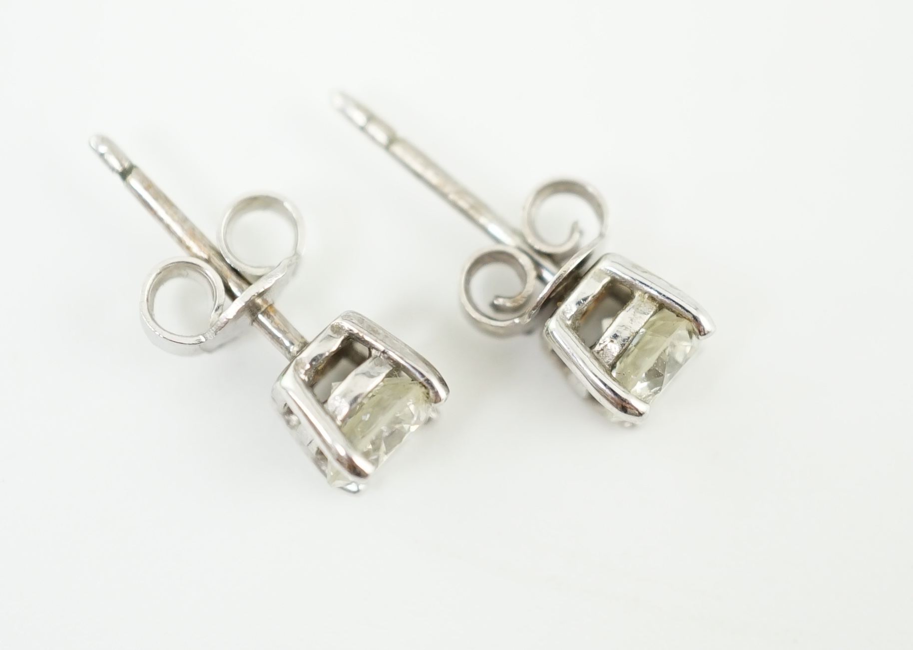 A pair of 18k white gold and solitaire diamond set ear studs